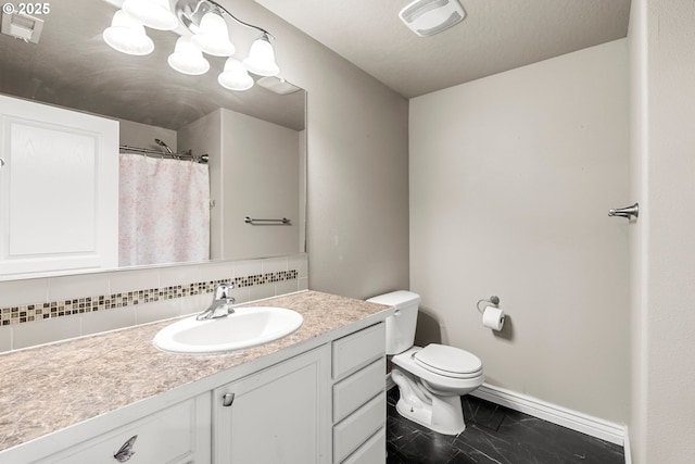 bathroom featuring tasteful backsplash, vanity, toilet, and an inviting chandelier