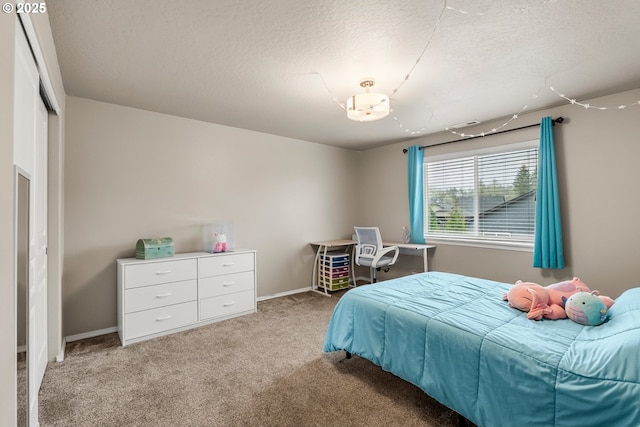 bedroom featuring light colored carpet and a textured ceiling