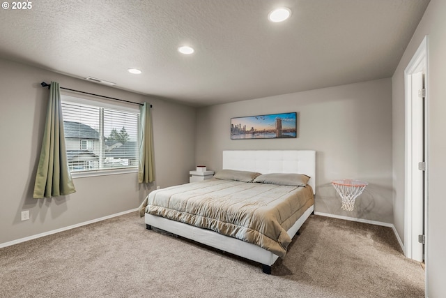 carpeted bedroom with a textured ceiling