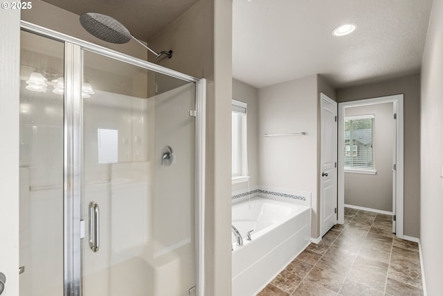 bathroom featuring separate shower and tub