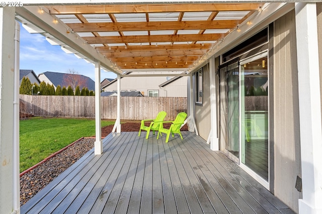 wooden deck featuring a lawn