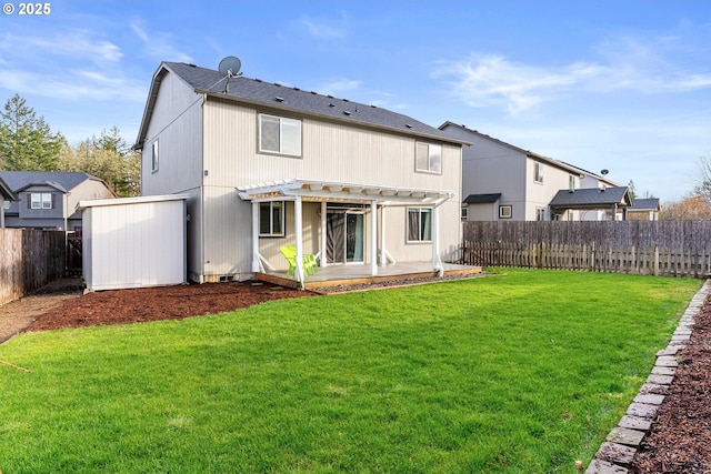 rear view of house featuring a pergola and a lawn