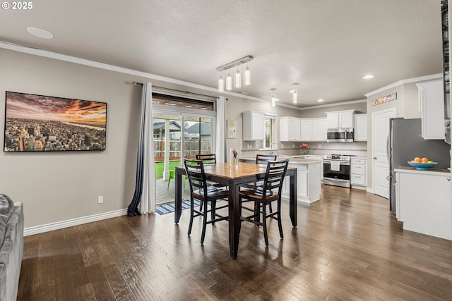 dining room featuring dark wood-type flooring and ornamental molding