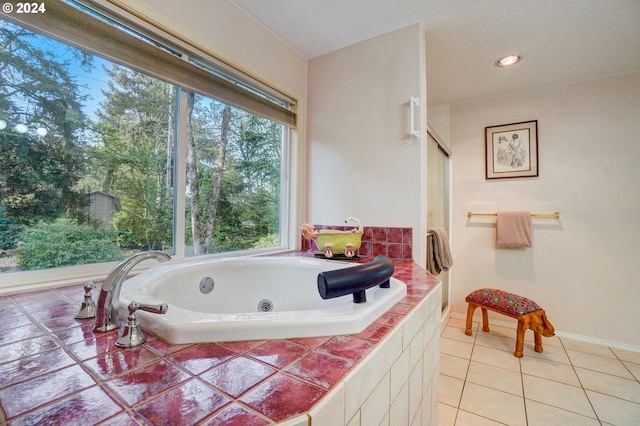 bathroom featuring tile patterned floors and tiled bath