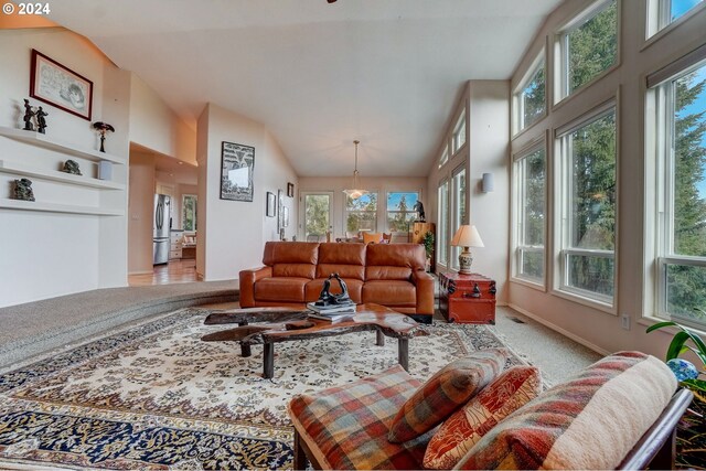 living room with lofted ceiling, carpet flooring, and a fireplace