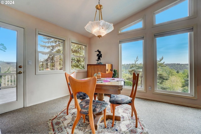 carpeted living room with lofted ceiling and a tile fireplace