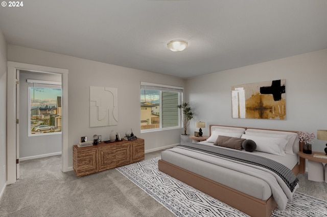 bedroom featuring light colored carpet