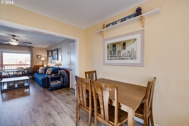 dining room featuring hardwood / wood-style floors, ceiling fan, and crown molding