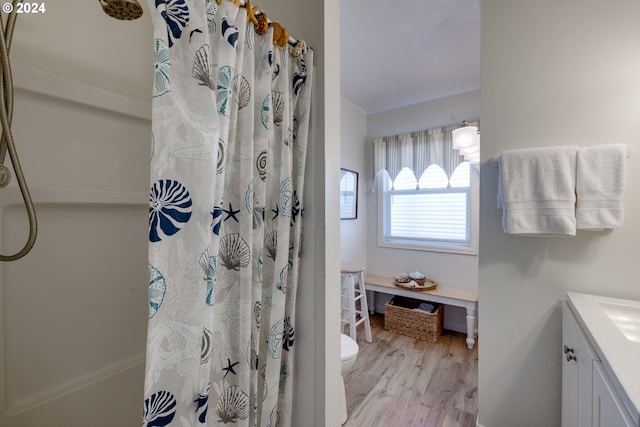 bathroom featuring ornamental molding, a shower with curtain, vanity, hardwood / wood-style floors, and toilet