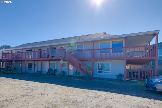 rear view of house featuring a wooden deck