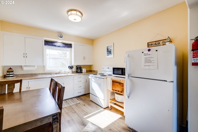 kitchen with light hardwood / wood-style floors, white cabinetry, white appliances, and sink