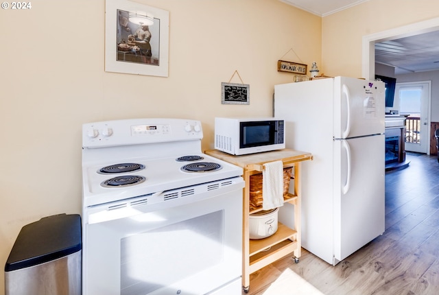 kitchen with white appliances and light wood-type flooring