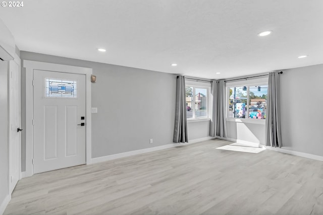 foyer entrance with light hardwood / wood-style flooring