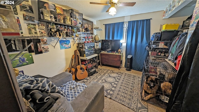 interior space with ceiling fan, light carpet, and a textured ceiling