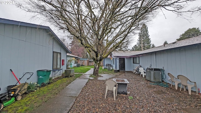 view of yard featuring central AC unit and a fire pit