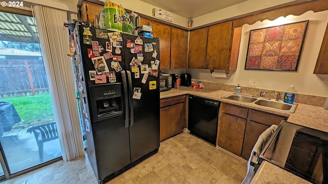 kitchen with sink, a healthy amount of sunlight, and black appliances