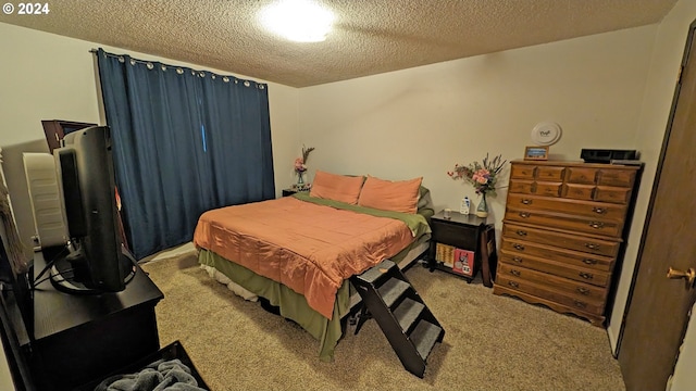 bedroom featuring light carpet and a textured ceiling