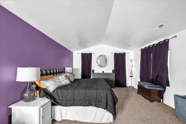 bedroom with a textured ceiling, light carpet, and lofted ceiling