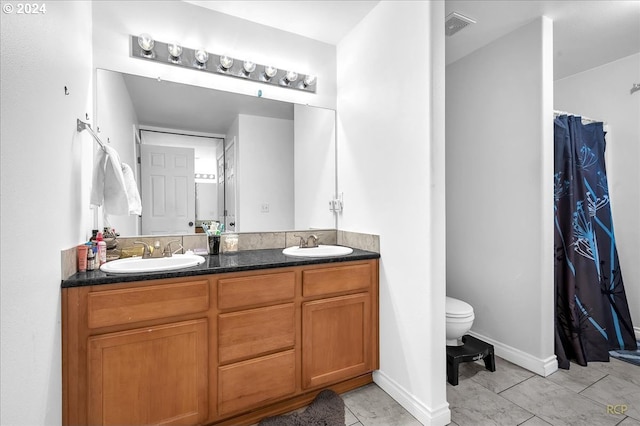 bathroom with tile patterned floors, toilet, and vanity