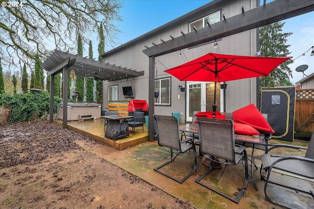 view of patio / terrace featuring a wooden deck, a hot tub, and a pergola