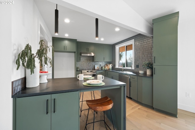 kitchen featuring backsplash, green cabinets, sink, stainless steel dishwasher, and light wood-type flooring