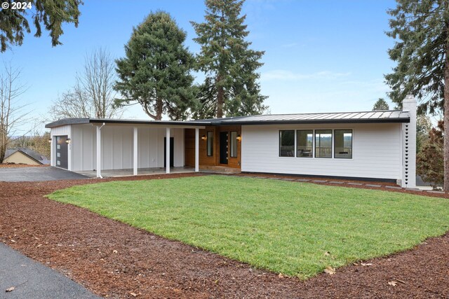 view of front facade with a front yard and a garage