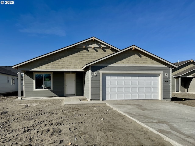 ranch-style home with an attached garage and concrete driveway