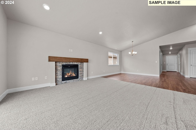 unfurnished living room featuring baseboards, lofted ceiling, an inviting chandelier, a stone fireplace, and recessed lighting