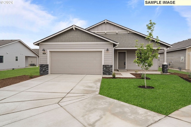 craftsman inspired home featuring a garage, central AC unit, and a front lawn