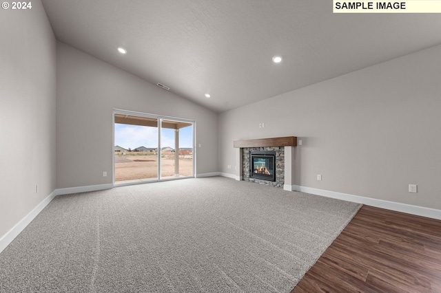 unfurnished living room with high vaulted ceiling, recessed lighting, a stone fireplace, and baseboards