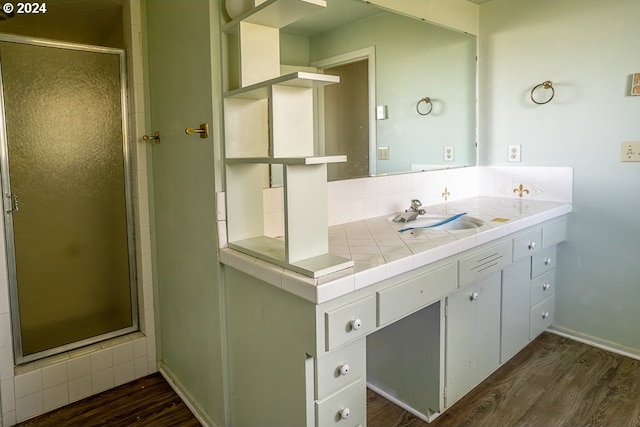 bathroom featuring walk in shower, vanity, and hardwood / wood-style flooring