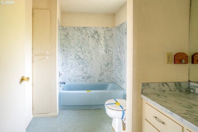 bathroom featuring a bathing tub, vanity, and toilet