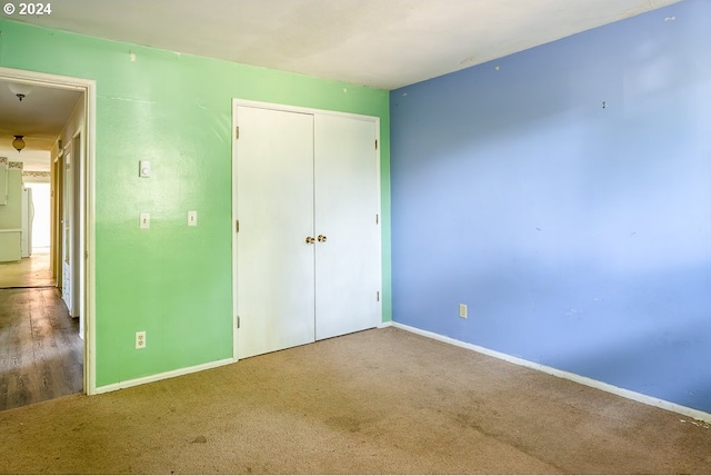 unfurnished bedroom with hardwood / wood-style floors and a closet