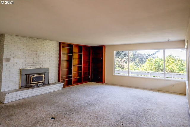 unfurnished living room featuring a wood stove and light carpet