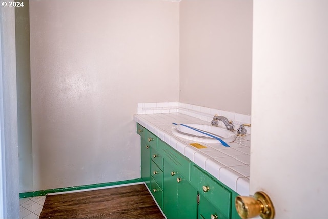 bathroom with vanity and hardwood / wood-style flooring