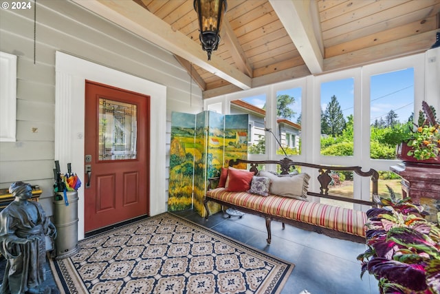 sunroom featuring vaulted ceiling with beams and wooden ceiling