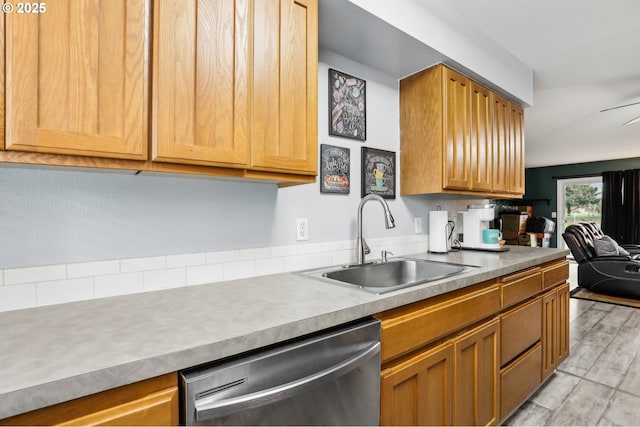 kitchen featuring ceiling fan, dishwasher, and sink