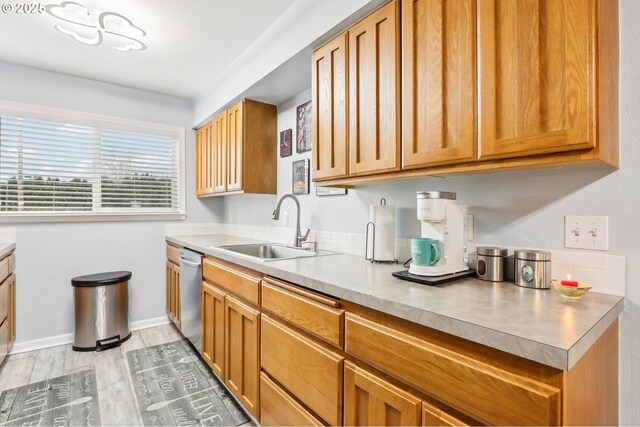 1763 NE 19th St, Gresham, OR 97030 - kitchen with dishwasher, light wood-style floors, light countertops, and brown cabinetry