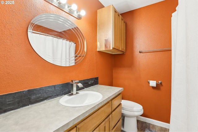 bathroom featuring vanity and toilet