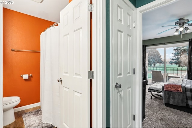 bathroom featuring ceiling fan, wood-type flooring, and toilet