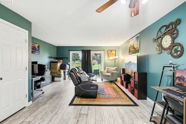 living room featuring light hardwood / wood-style flooring and ceiling fan