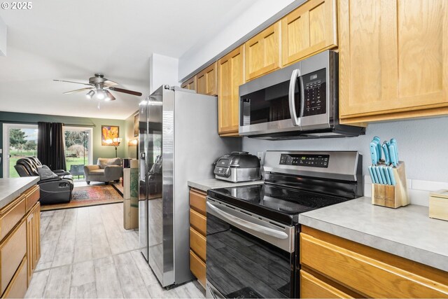 1763 NE 19th St, Gresham, OR 97030 - kitchen featuring stainless steel appliances, a ceiling fan, open floor plan, light wood finished floors, and light countertops