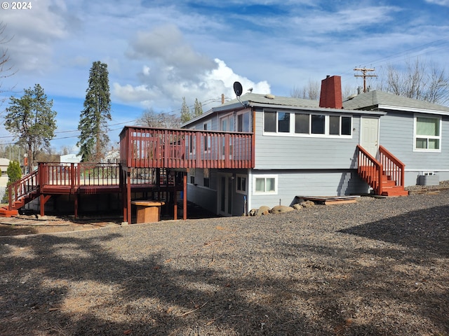 back of property featuring central AC unit and a deck