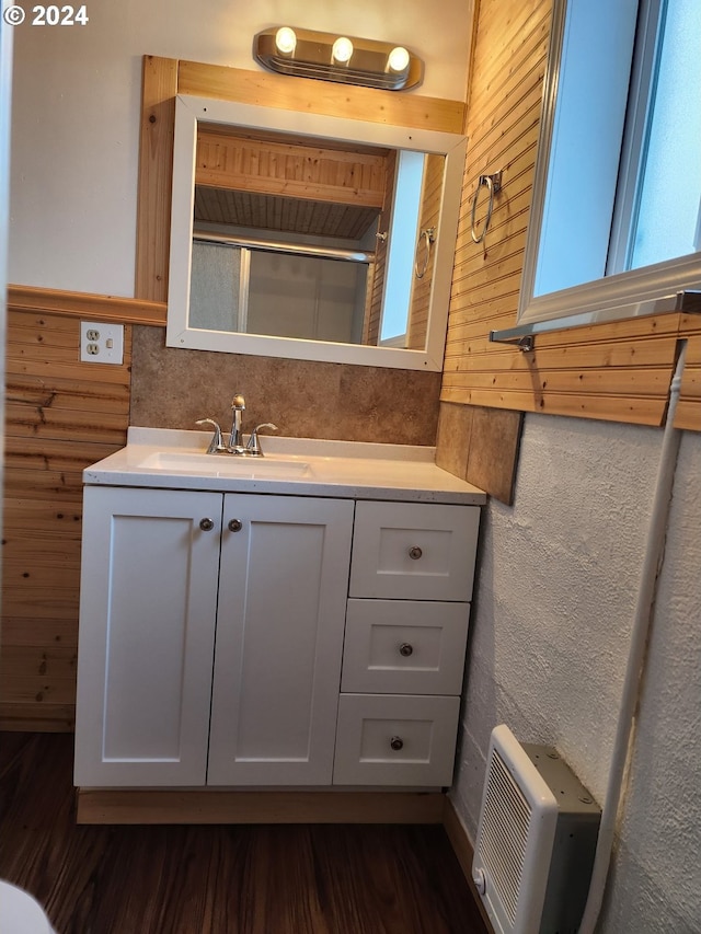 bathroom with vanity, wood walls, and hardwood / wood-style flooring