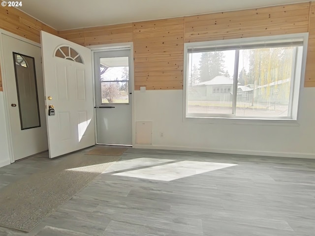 interior space with a healthy amount of sunlight and wood walls