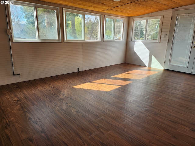 unfurnished sunroom featuring lofted ceiling and wooden ceiling