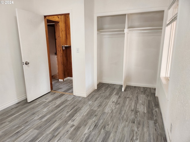 unfurnished bedroom featuring a closet and wood-type flooring