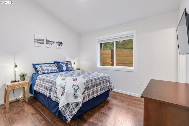 bedroom with dark hardwood / wood-style floors and vaulted ceiling