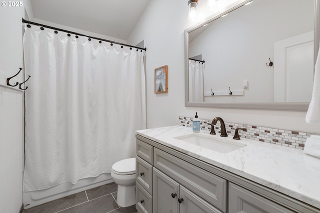 full bathroom with tile patterned floors, vaulted ceiling, toilet, shower / tub combo with curtain, and vanity