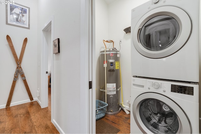 laundry room featuring hardwood / wood-style floors, stacked washer / dryer, and water heater